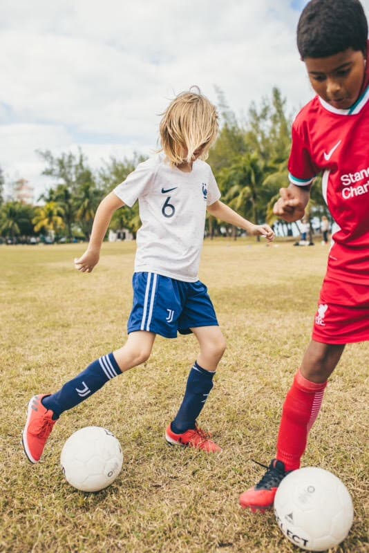 A young Futprep player controlling the ball.